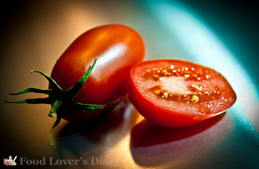 Tomato photographed on a stainless steel sheet lit with an ordinary reading lamp